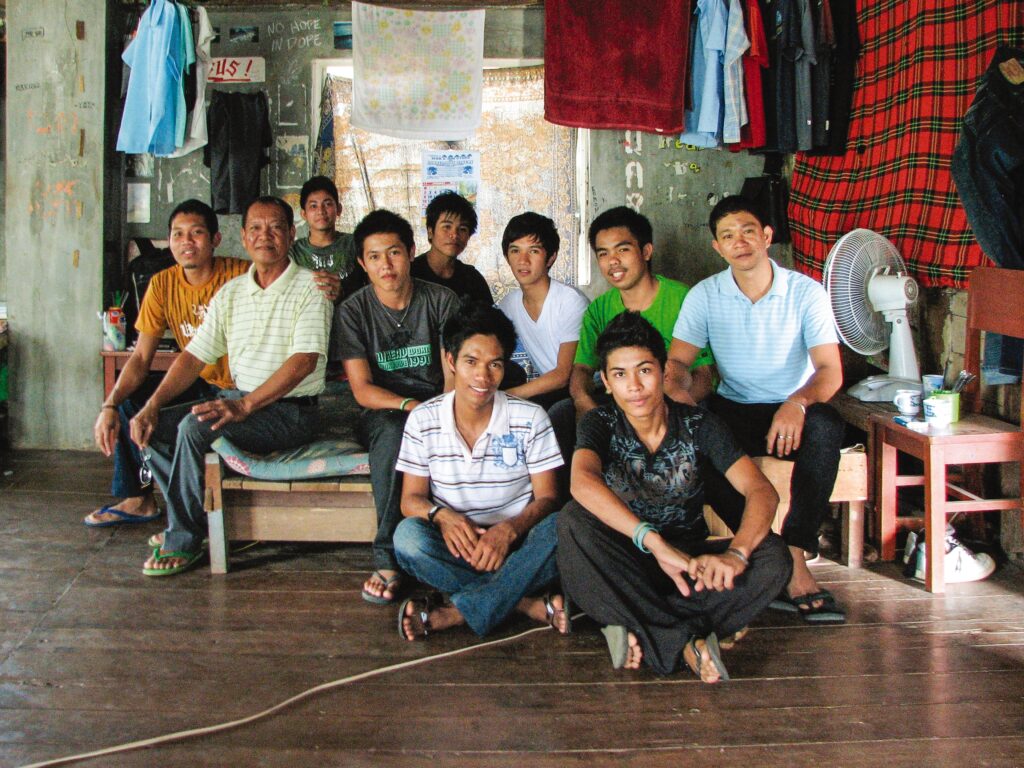 a group of men sit inside a church and smile at the camera 
