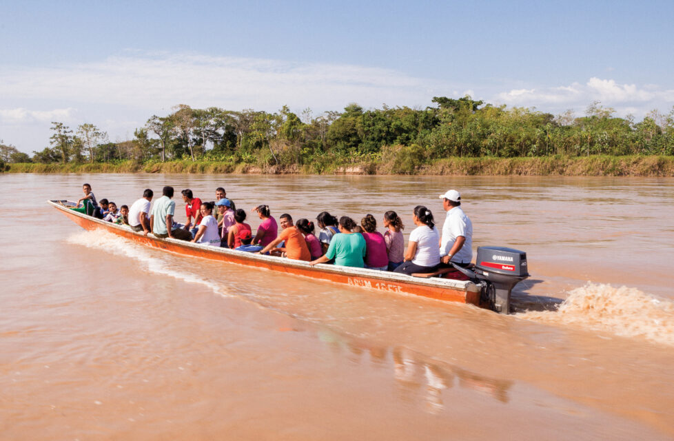 Colombian Pastor and Wife Face Continuous Danger in “Red Zones” A group of people in a canoe going up the river