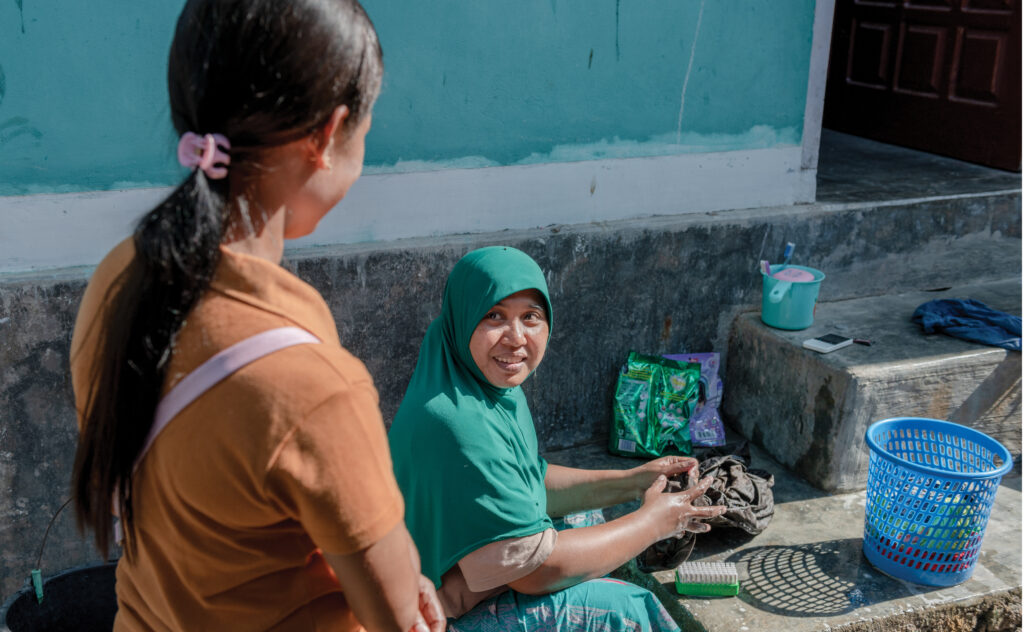 indonesian woman talks to woman in hijab