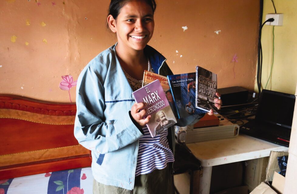 Colombian girl holds up literature