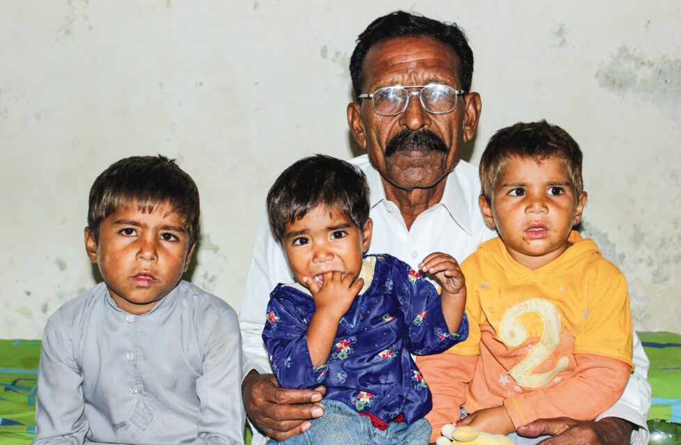 Pakistani Christians Murdered By Mob of Over 500 Muslims A man sits with his three kids